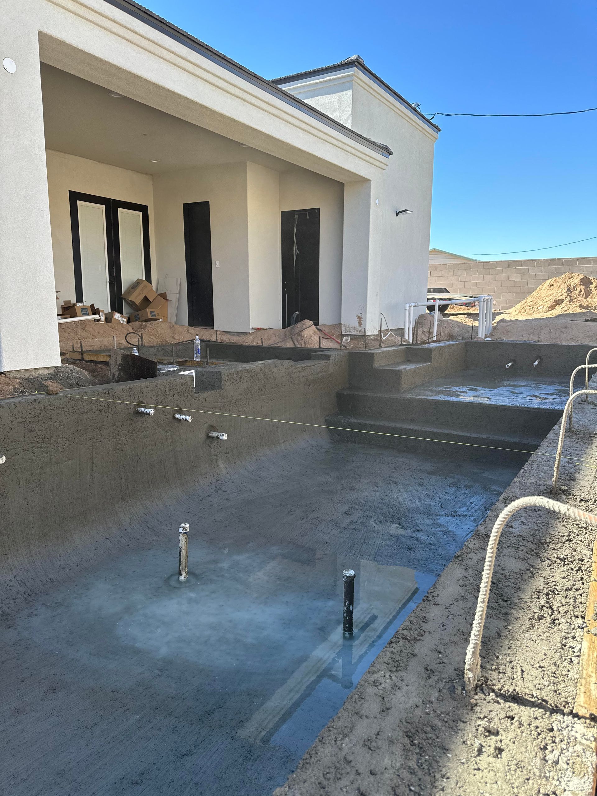 A swimming pool is being built in front of a house