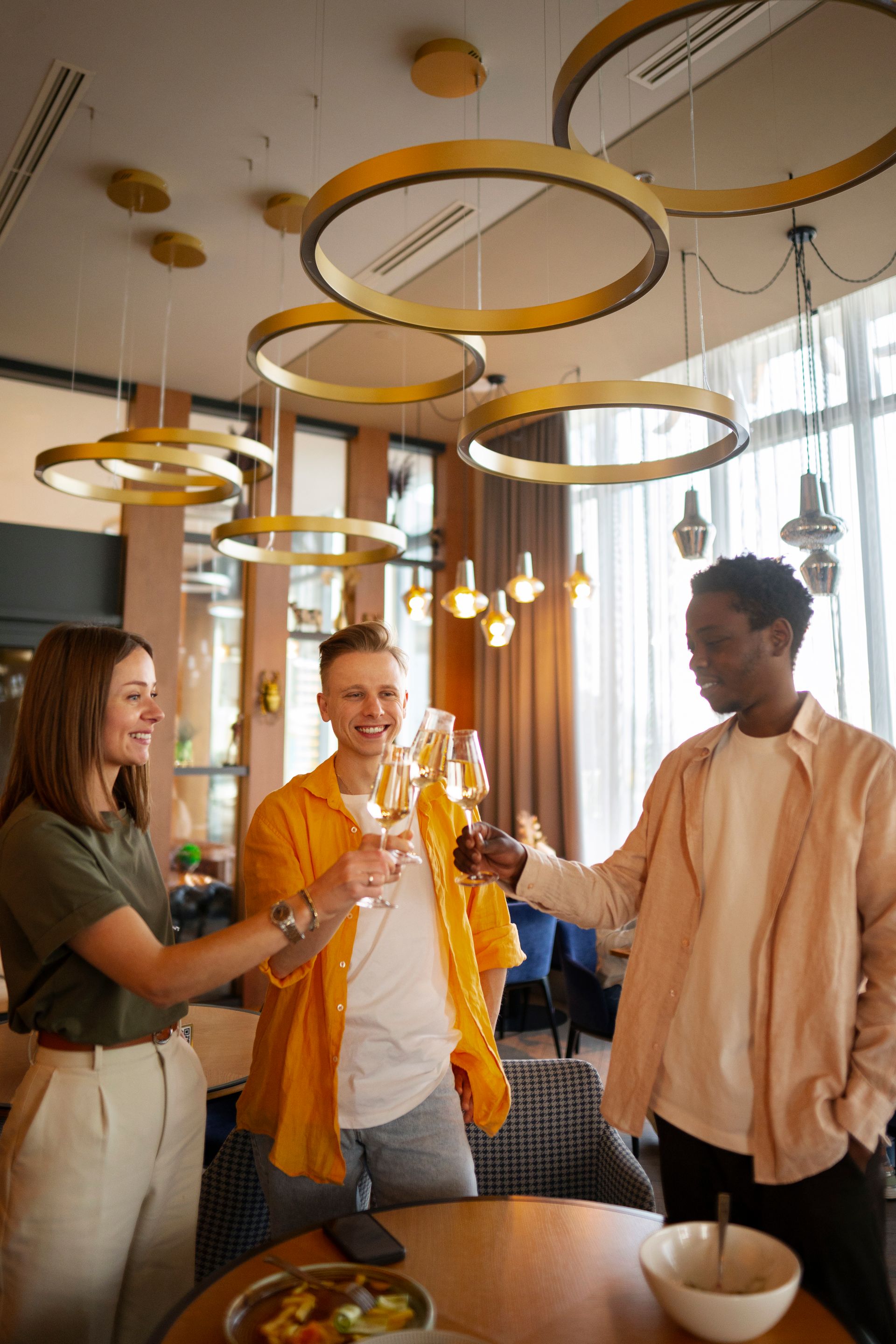 Gold lighting suspended from a white ceiling.