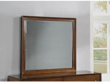 A mirror is sitting on top of a wooden dresser.