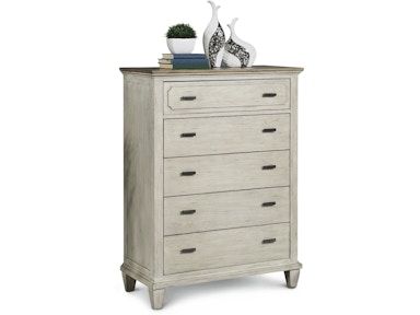 A white chest of drawers with vases on top of it