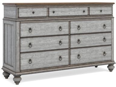 A dresser with nine drawers and a wooden top on a white background.