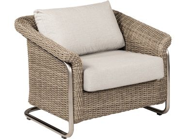 A wicker chair with a white cushion on a white background