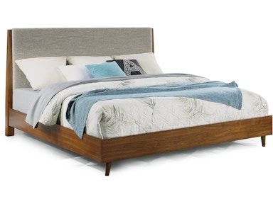 A bed with a blanket and pillows on it