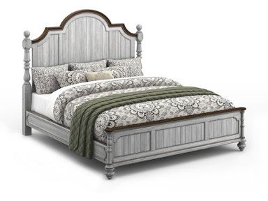 A bed with a blanket and pillows on it on a white background.