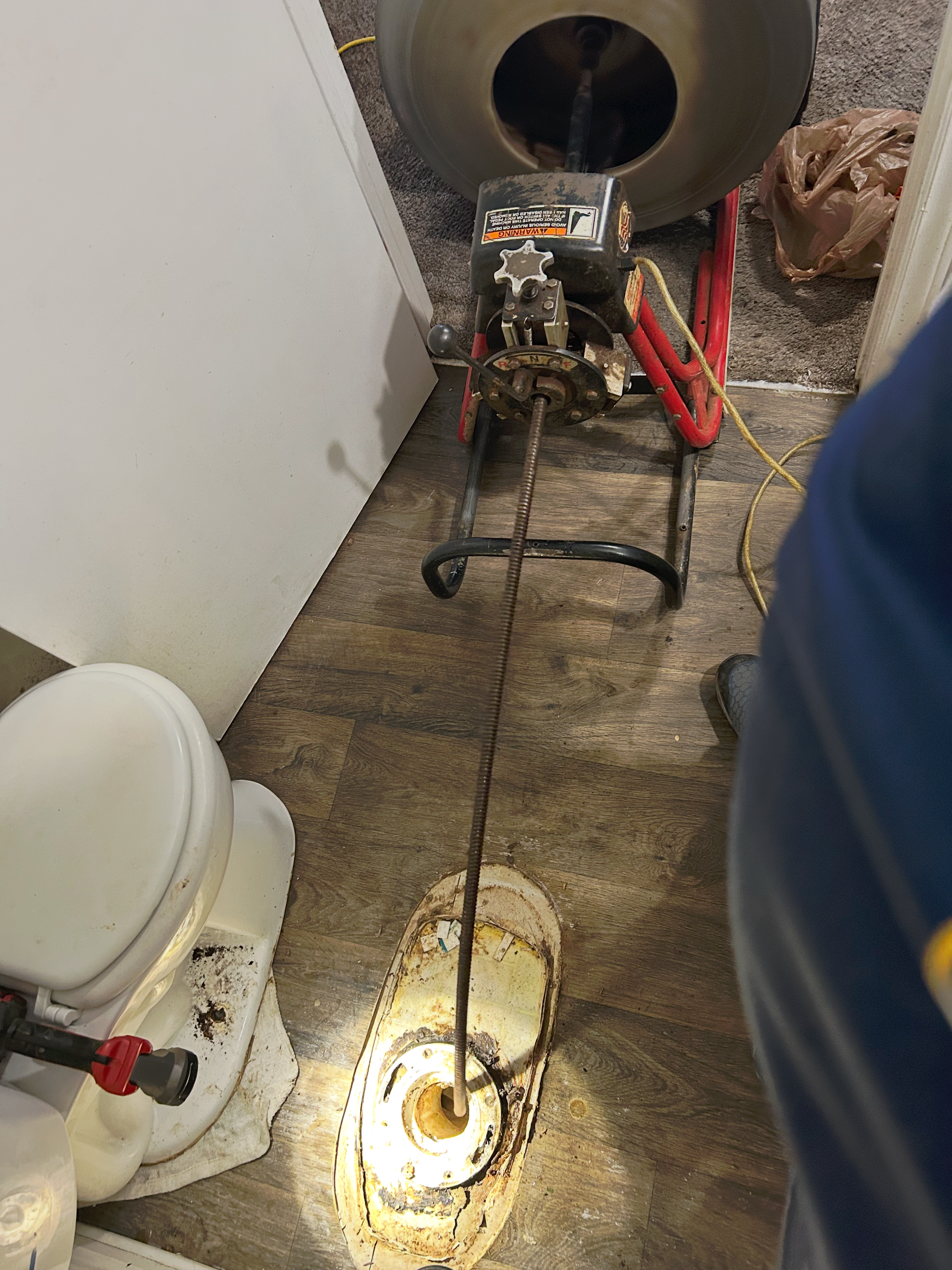 A drain cleaner is being used to clean a drain in a bathroom.