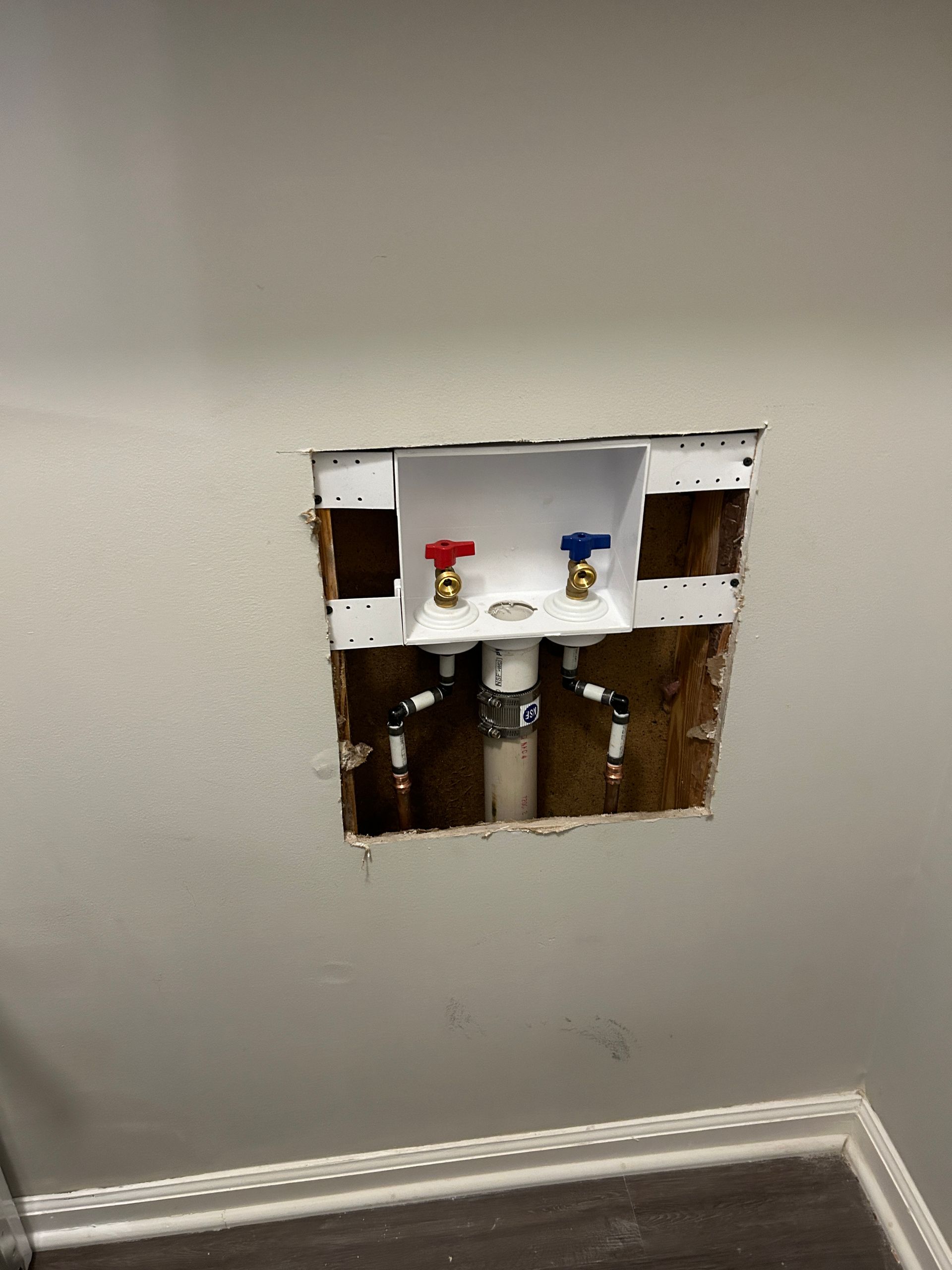 A hole in the wall with a faucet in it.