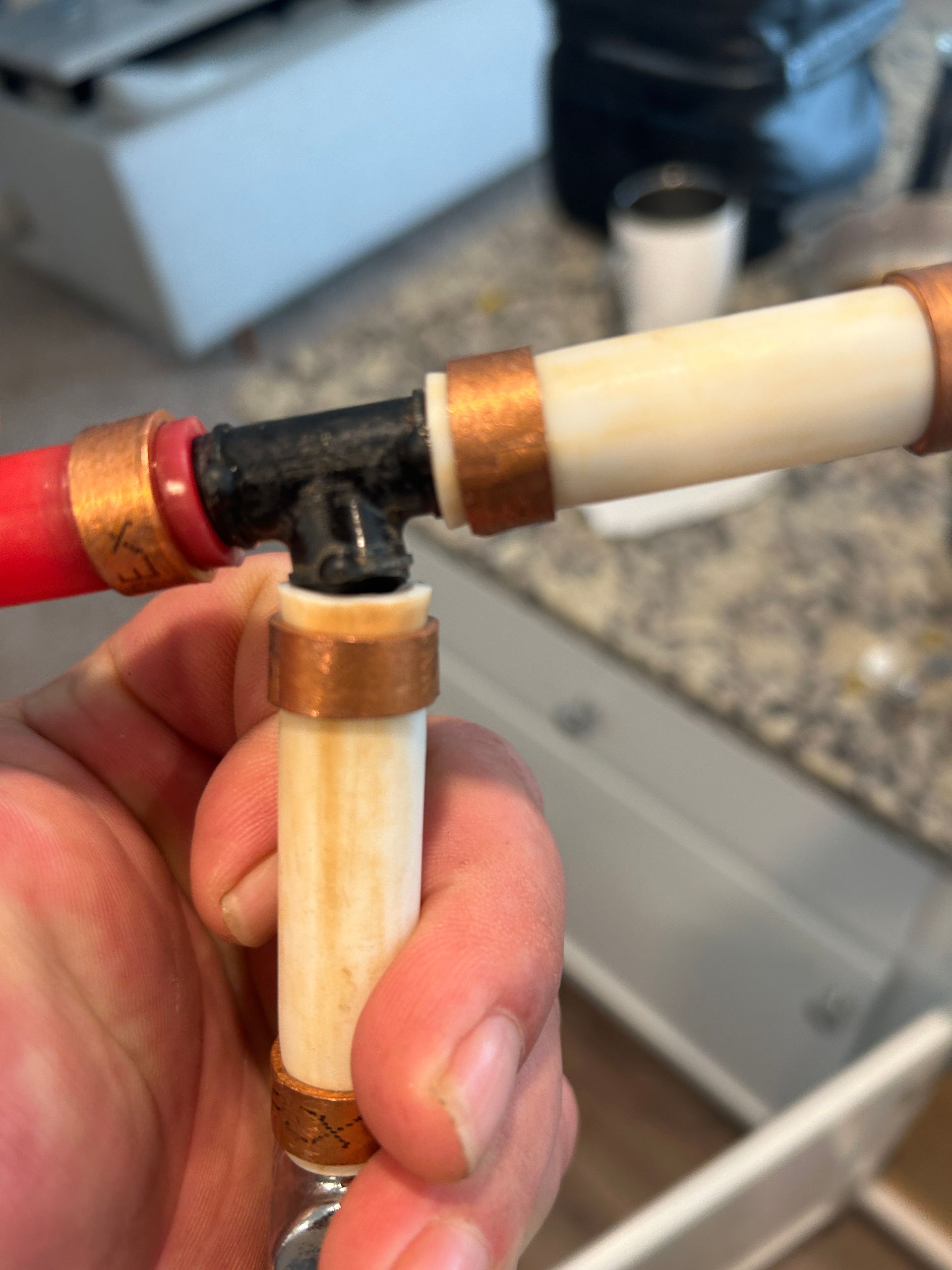 A person is holding a piece of pipe in their hand.