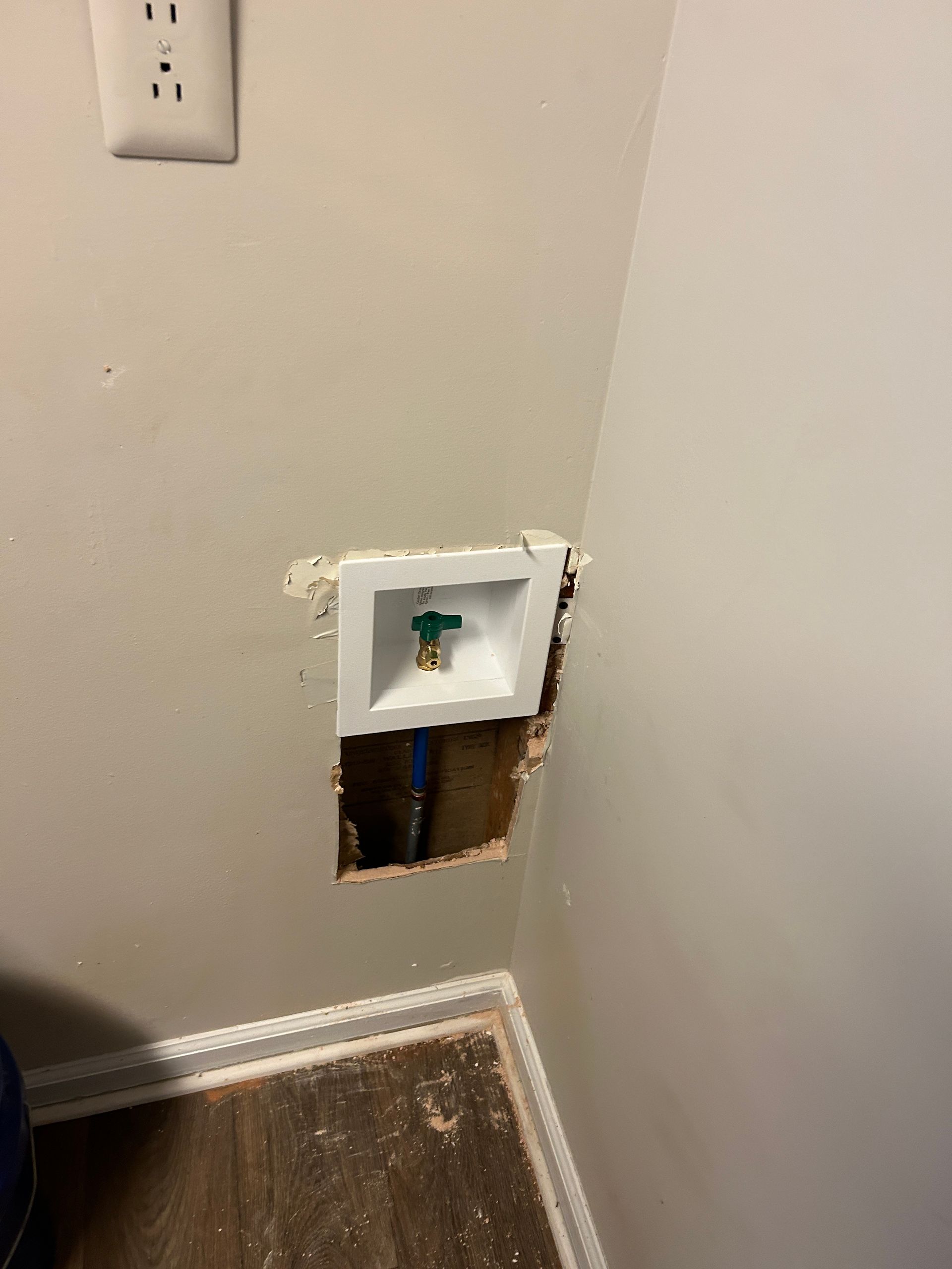 A hole in the wall with a faucet in it.