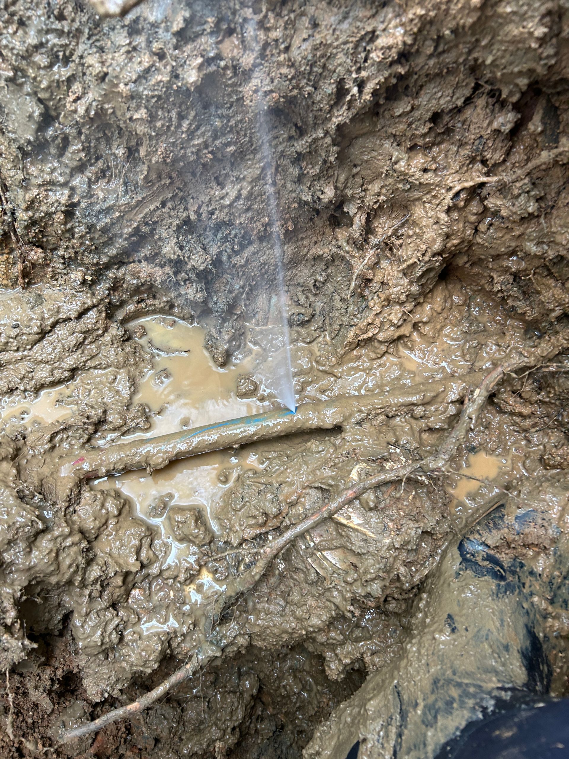 A close up of a hole in the ground with water coming out of it.