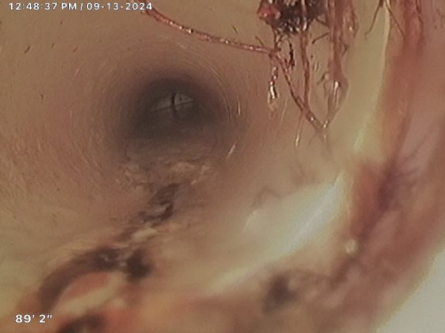 A close up of a drain with water coming out of it.