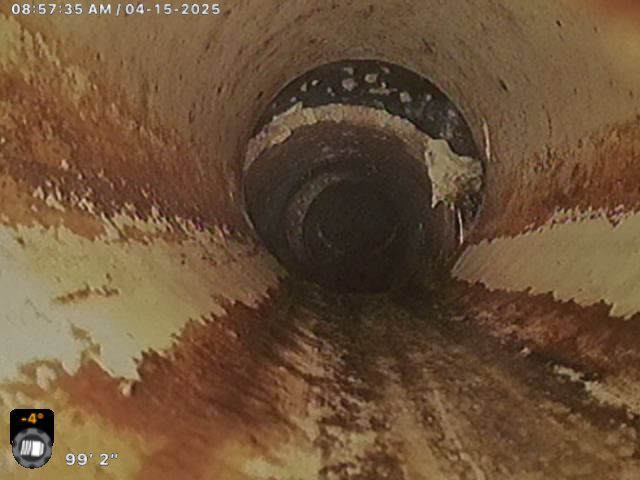 A camera is taking a picture of a dirty drain.