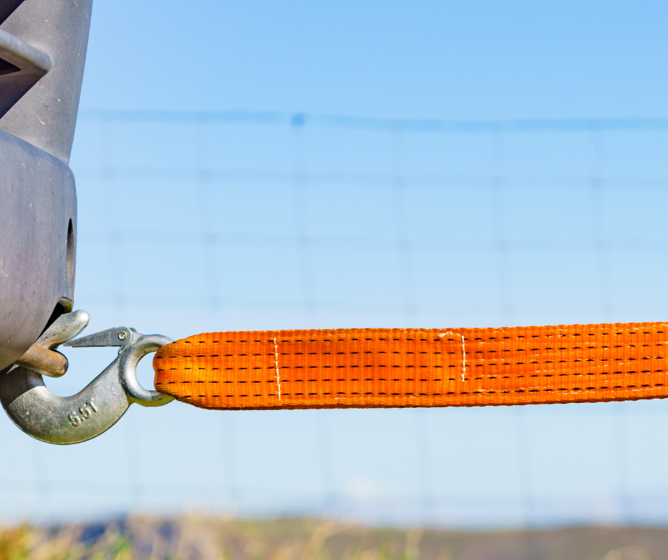 A close up of a tow strap attached to a vehicle.