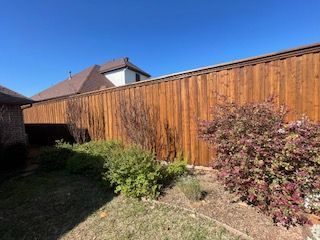 Wooden Fence Is in The Backyard of A House