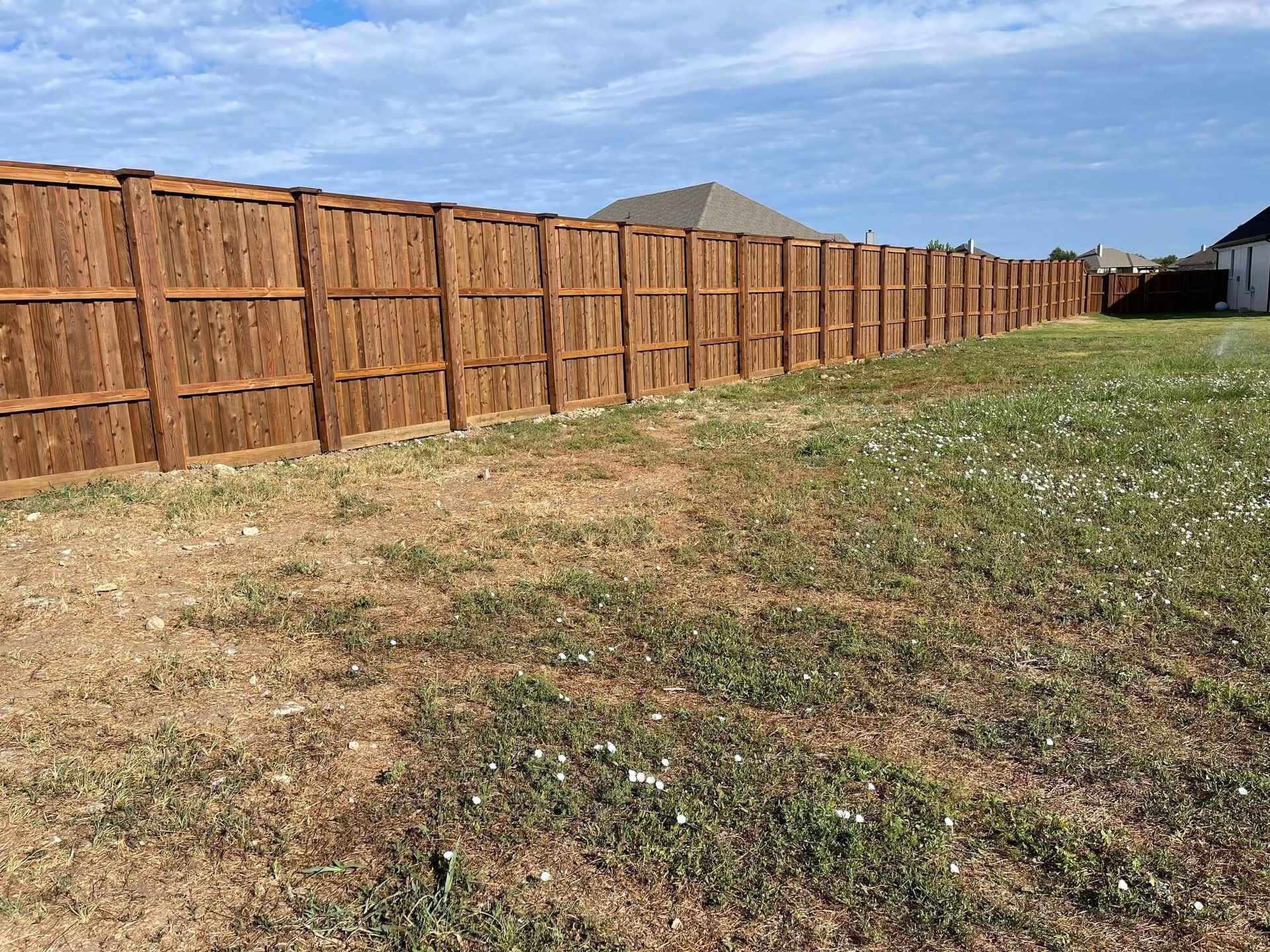 A Wooden Fence Is Sitting in The Middle of A Grassy Field
