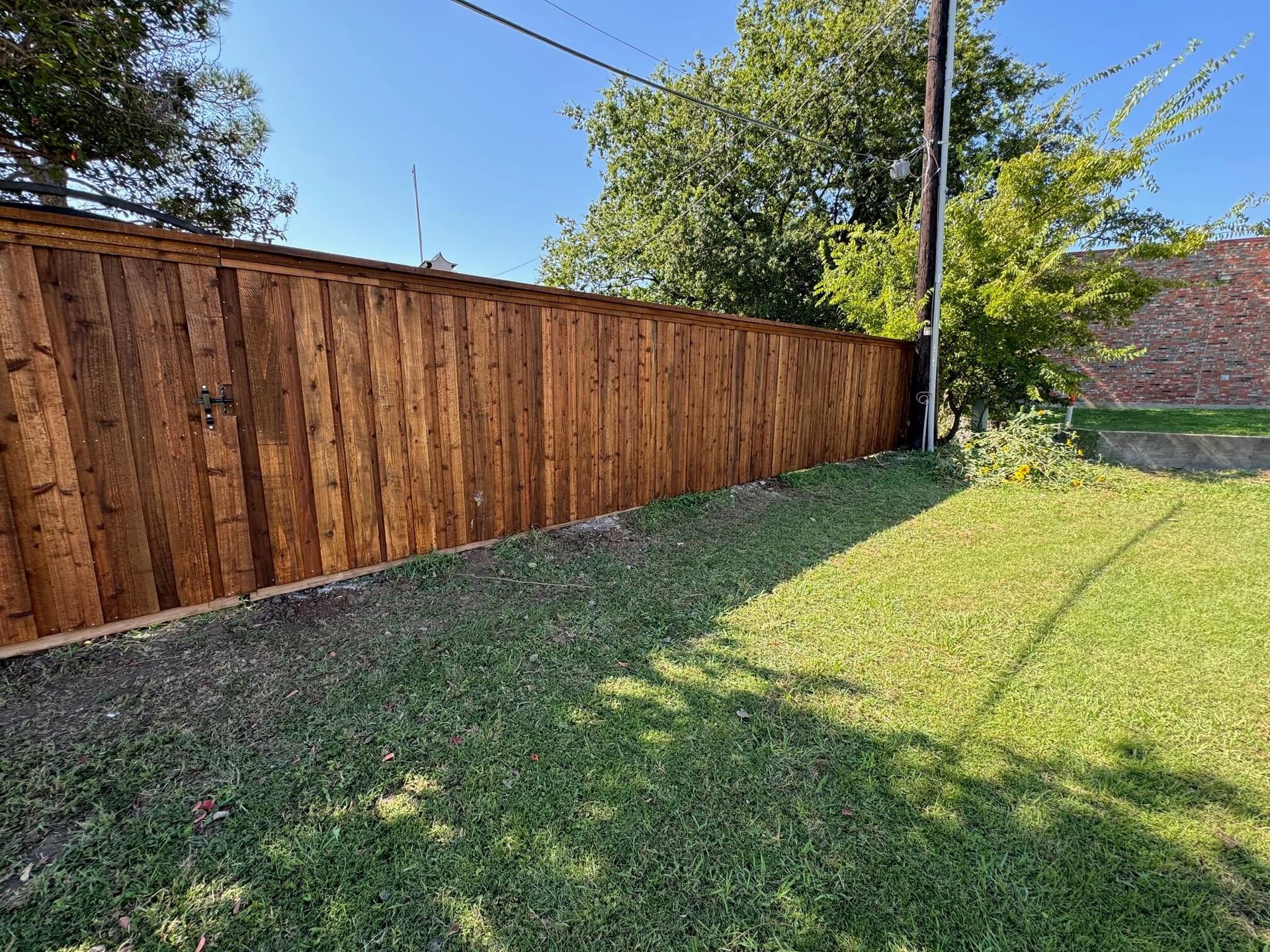 A Wooden Fence Surrounds a Lush Green Yard