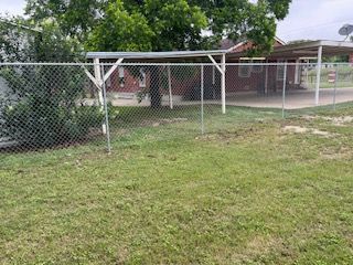 Chain Link Fence in Front of A House with A Carport