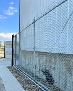 Chain Link Fence Along the Side of A Building