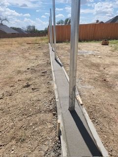 Fence Being Built in The Middle of A Dirt Field