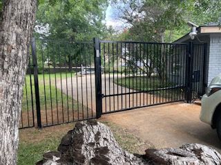 Car Parked in Front of A Wrought Iron Gate