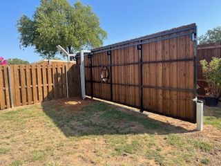 Wooden Fence with A Sliding Gate in The Backyard