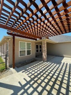 House with A Wooden Pergola Over the Driveway
