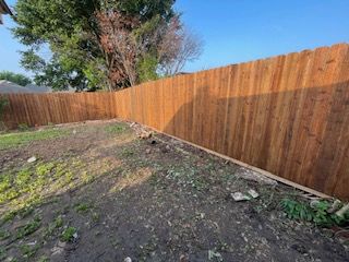 Wooden Fence in A Backyard with A Tree in The Background