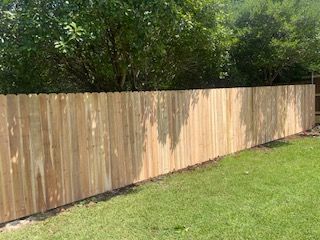 Wooden Fence on Top of A Lush Green Lawn