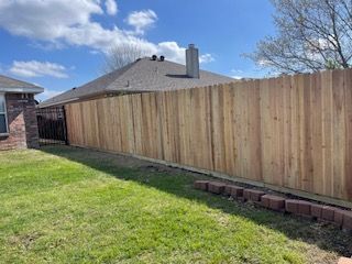 Wooden Fence Is in The Backyard of A House
