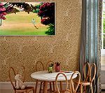 Child's play area with round table, chairs, and artwork of a green field.