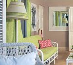 White wicker furniture with lime green accents in a bright room.