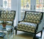 Two armchairs with geometric patterned upholstery in a bright room.