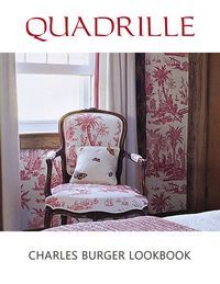 A vintage chair upholstered in pink toile fabric. Curtains and wallpaper match the pattern.