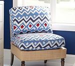 Armless chair with blue and white patterned cushions, tan base, and dark wood legs.