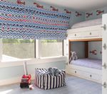 Nautical-themed kids' room with bunk beds, patterned Roman shade, lobster wall decals, and striped ottoman.