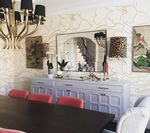 Dining room with a lilac buffet, gold chandelier, and ornate mirror.