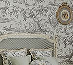 Bedroom with toile wallpaper, bed, pillows, and a framed artwork.