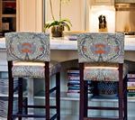 Two patterned bar stools at a white countertop in a kitchen.