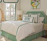 Bedroom with a mint green bed, white bedding, and a personalized pillow.