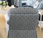 Upholstered chair with blue and gray patterned fabric.