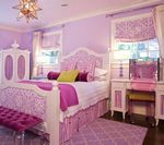 Lavish lilac bedroom with ornate white furniture, pink accents, and a gold starburst light.
