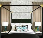 Bedroom with canopy bed, nightstands, lamps, and tan curtains.