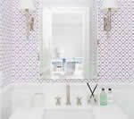 White bathroom with purple patterned tile, mirror, sink, and silver fixtures.