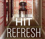 Hallway with red and white patterned wallpaper, dark furniture, and the words 