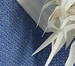 White paper sculpture against blue textured background.