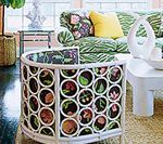 Living room with floral sofa, white coffee table, and unique round side table with floral detail.