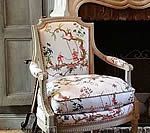 Beige armchair with floral fabric.