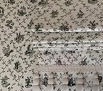 Wallpaper with dark green floral pattern and white trim.