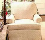 Beige patterned armchair in a room.