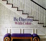 A staircase with white banister, black steps, and a purple bench. Text reads 