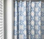 Blue patterned shower curtain with white accents, next to dotted wallpaper and a white shutter.